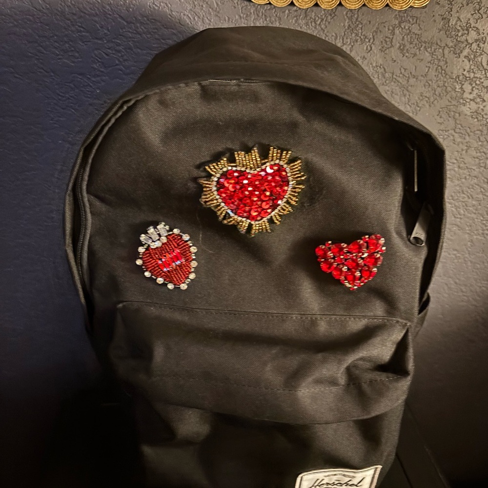 Herschel Black Backpack with Red Heart Embellishments. New.
